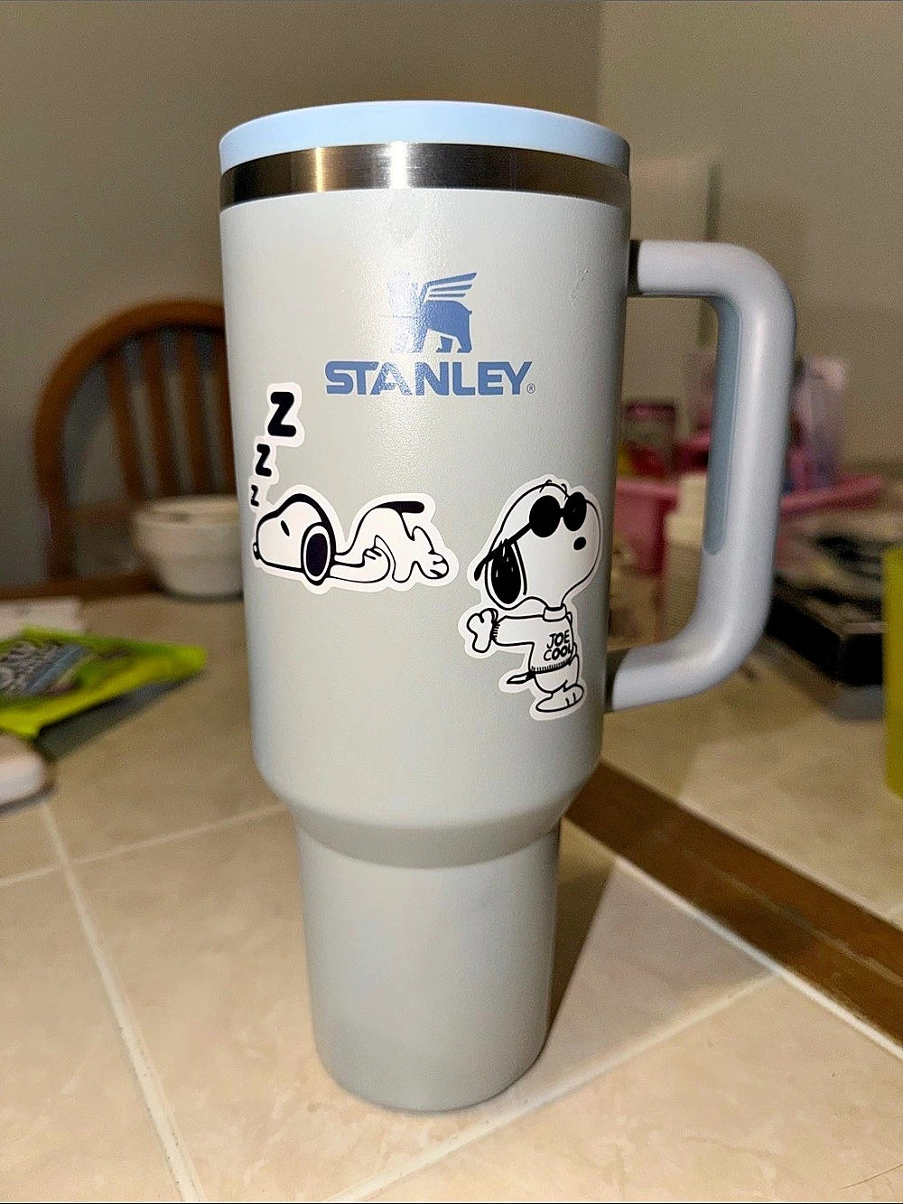 Stanley Quencher H2.0 FlowState Tumbler in light blue with snoopy stickers